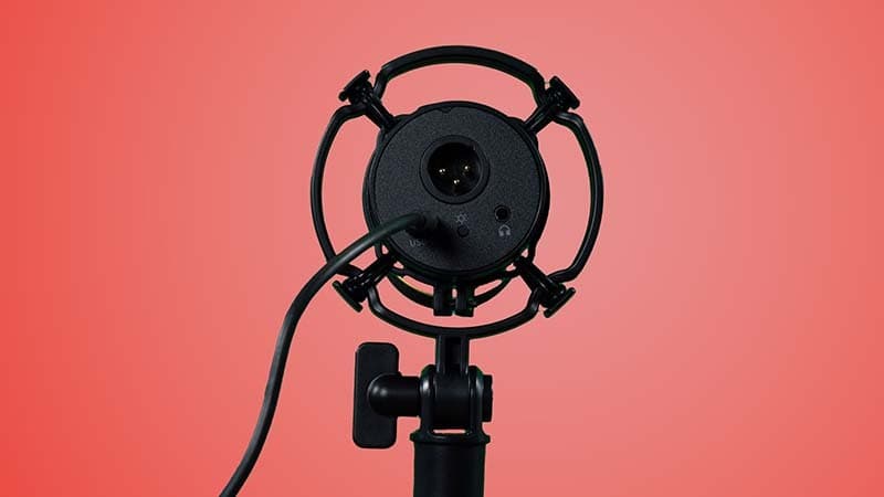 Image shows the back of a PD200x microphone, including the XLR & USB-C inputs.. The microphone is also attached to a desk stand and the front end is pointing directly away from the camera.