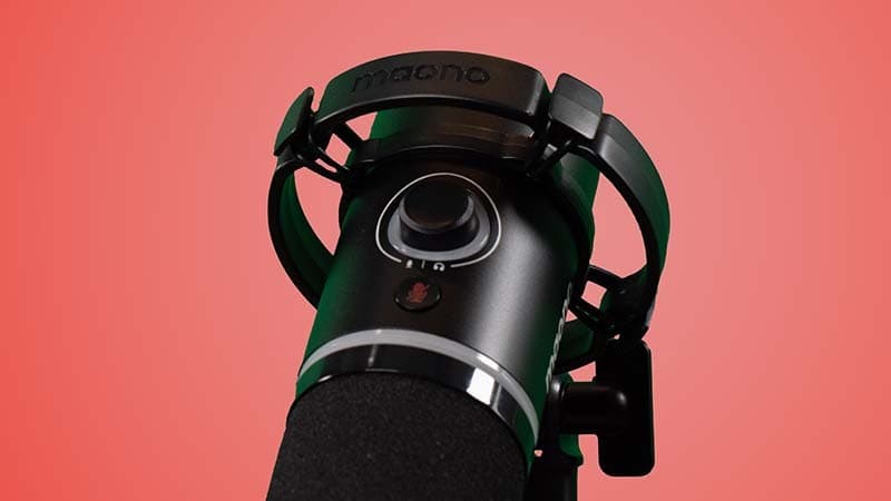 Image shows the smart knob and mute button on a PD200X microphone, set against a salmon coloured background.