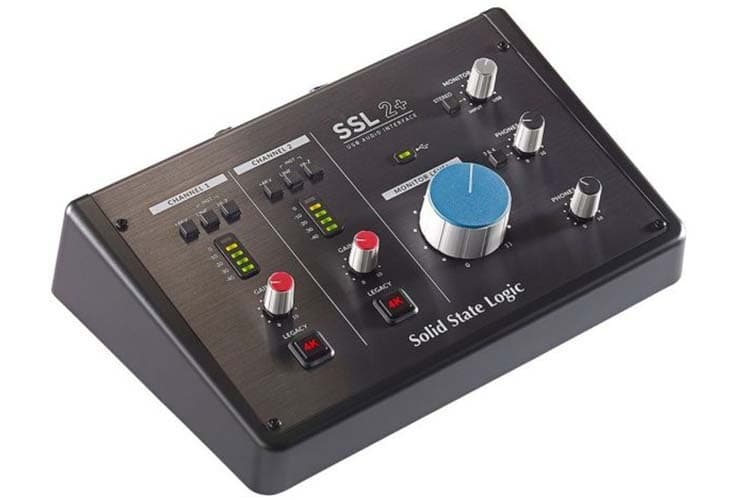 ALT: The SSL 2+ audio interface. A black wedge shape interface with various meters and dials on the top.