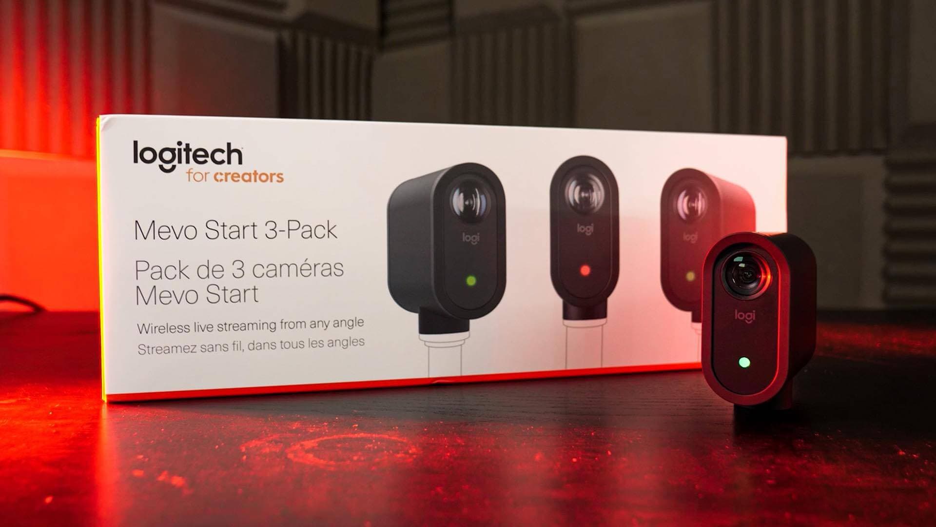 The Logitech Mevo Start-3 pack box on a table with one Mevo standing upright in front of the box.